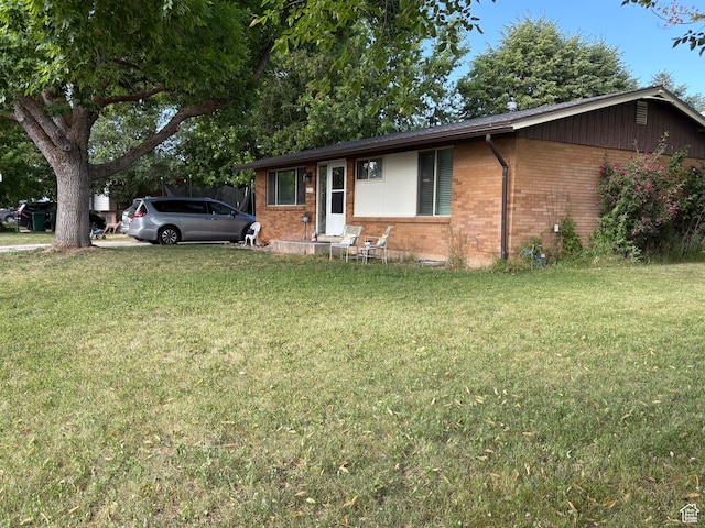 6072 S 2550 W, Roy, UT 84067 - ranch-style home featuring brick siding and a front lawn