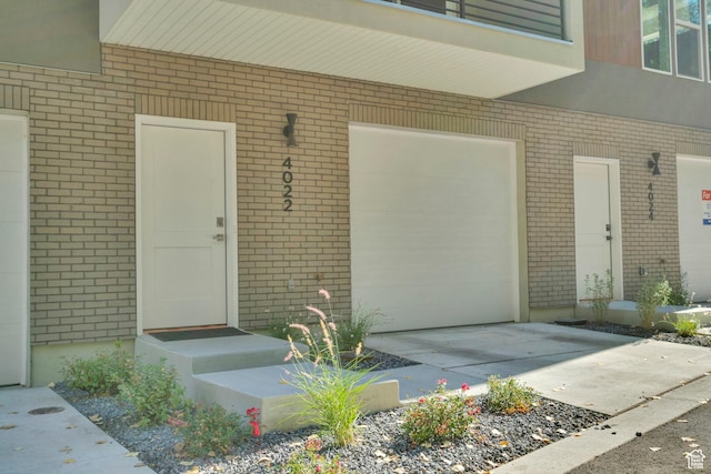 4022 S Burch Creek Way S, Ogden, UT 84405 - doorway to property featuring brick siding and a garage