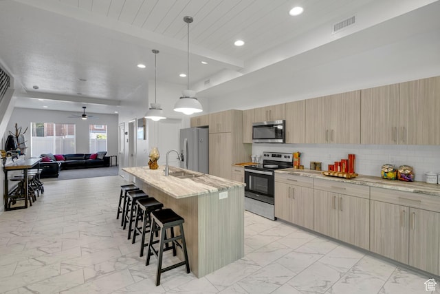 4022 S Burch Creek Way S, Ogden, UT 84405 - kitchen featuring stainless steel appliances, light marble finish flooring, a breakfast bar area, a sink, and recessed lighting