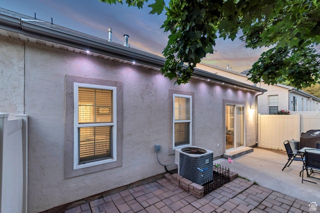 3094 E Somerset Dr, Spanish Fork, UT 84660 - rear view of house with central AC unit, a patio, and stucco siding