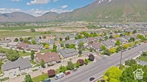 3094 E Somerset Dr, Spanish Fork, UT 84660 - aerial overview of property's location with a mountainous background and nearby suburban area