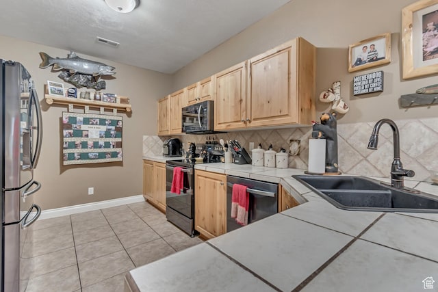 3094 E Somerset Dr, Spanish Fork, UT 84660 - kitchen with stainless steel appliances, a sink, light brown cabinetry, tasteful backsplash, and light tile patterned floors