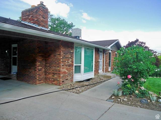 783 N Highland Blvd, Brigham City, UT 84302 - view of side of home with a chimney and brick siding