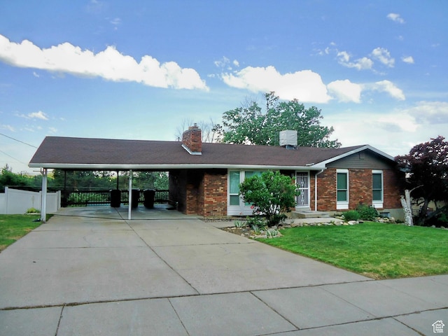 783 N Highland Blvd, Brigham City, UT 84302 - ranch-style home featuring brick siding, concrete driveway, a chimney, and an attached carport