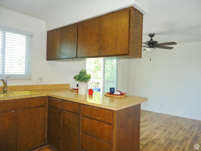 783 N Highland Blvd, Brigham City, UT 84302 - kitchen with a peninsula, ceiling fan, light countertops, a sink, and wood finished floors