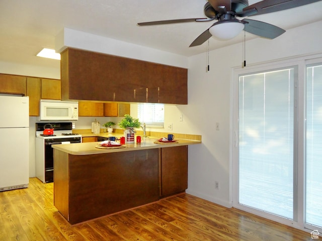 783 N Highland Blvd, Brigham City, UT 84302 - kitchen featuring white appliances, a peninsula, brown cabinets, a ceiling fan, and light countertops