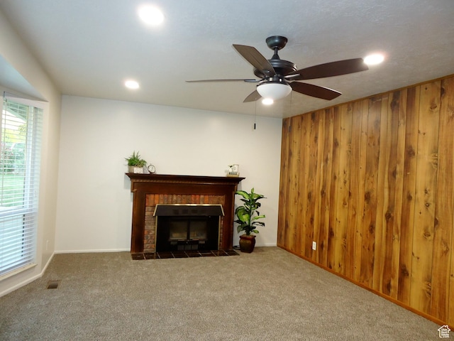 783 N Highland Blvd, Brigham City, UT 84302 - unfurnished living room featuring carpet flooring, a fireplace, wood walls, ceiling fan, and recessed lighting