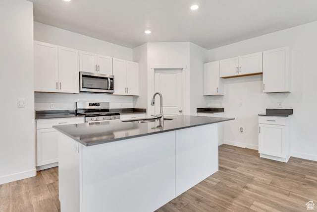 3800 W 560 N Unit 509, Lehi, UT 84043 - kitchen featuring appliances with stainless steel finishes, a sink, dark countertops, white cabinets, and recessed lighting