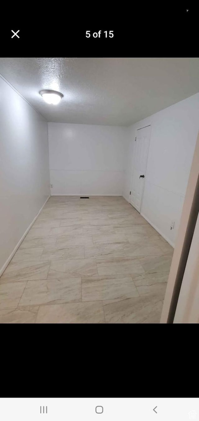 4781 S 3040 W, Taylorsville, UT 84129 - spare room featuring baseboards and a textured ceiling