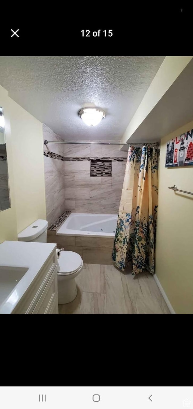 4781 S 3040 W, Taylorsville, UT 84129 - full bath with a textured ceiling, vanity, shower / tub combo with curtain, toilet, and marble finish flooring
