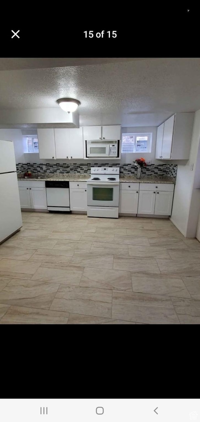 4781 S 3040 W, Taylorsville, UT 84129 - kitchen featuring white appliances, white cabinetry, and a textured ceiling
