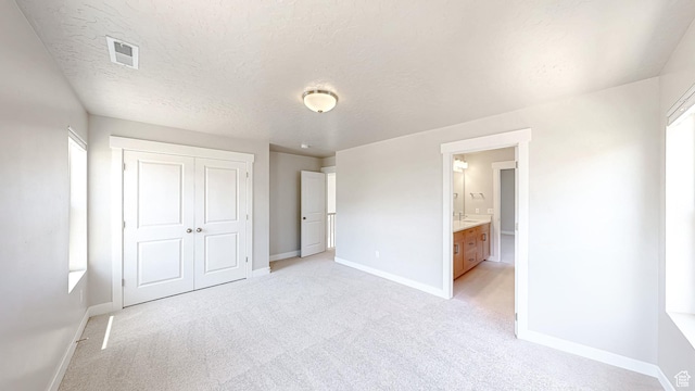 833 N Union Bench Dr W Unit 62, Mapleton, UT 84664 - unfurnished bedroom with baseboards, light carpet, a closet, and a textured ceiling