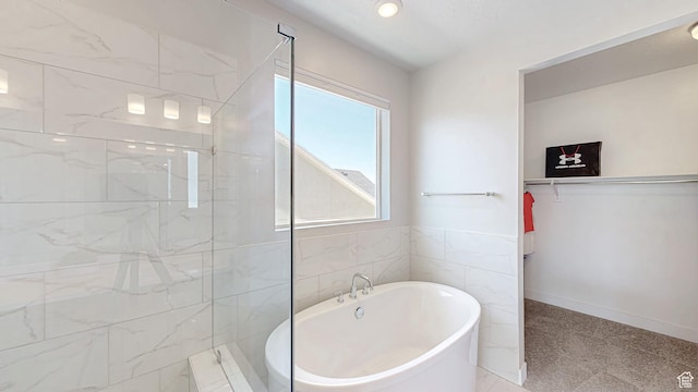 833 N Union Bench Dr W Unit 62, Mapleton, UT 84664 - bathroom with a soaking tub, a tile shower, a walk in closet, and tile walls