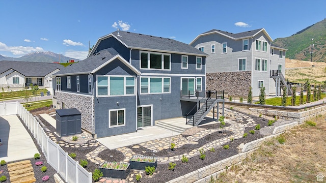833 N Union Bench Dr W Unit 62, Mapleton, UT 84664 - back of property with stairway, a fenced backyard, a patio, and stucco siding