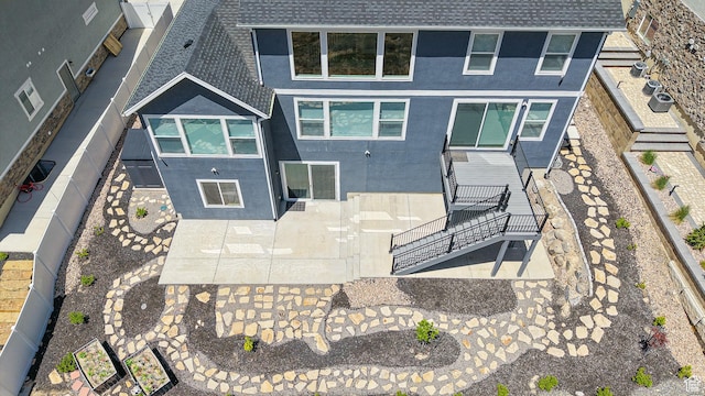 833 N Union Bench Dr W Unit 62, Mapleton, UT 84664 - rear view of property with stairs, roof with shingles, stucco siding, and a fenced backyard