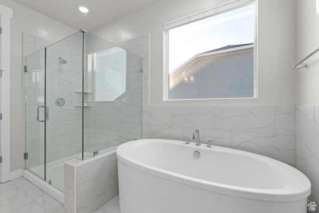 833 N Union Bench Dr W Unit 62, Mapleton, UT 84664 - full bath featuring marble finish flooring, a freestanding tub, a marble finish shower, tile walls, and recessed lighting