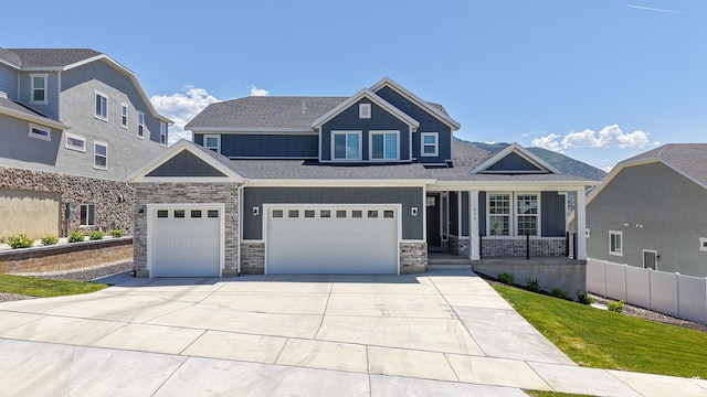 833 N Union Bench Dr W Unit 62, Mapleton, UT 84664 - view of front facade featuring board and batten siding, stone siding, covered porch, concrete driveway, and an attached garage