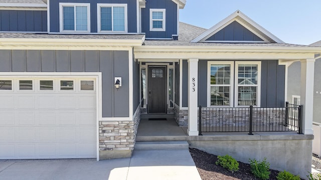 833 N Union Bench Dr W Unit 62, Mapleton, UT 84664 - view of exterior entry featuring a porch, board and batten siding, a shingled roof, and stone siding
