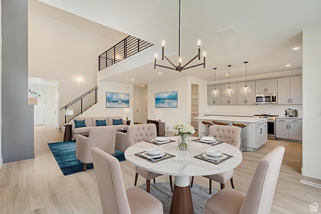 322 W Songbird Ln N Unit 24, Lindon, UT 84042 - dining area with light wood finished floors, recessed lighting, stairway, a chandelier, and a towering ceiling