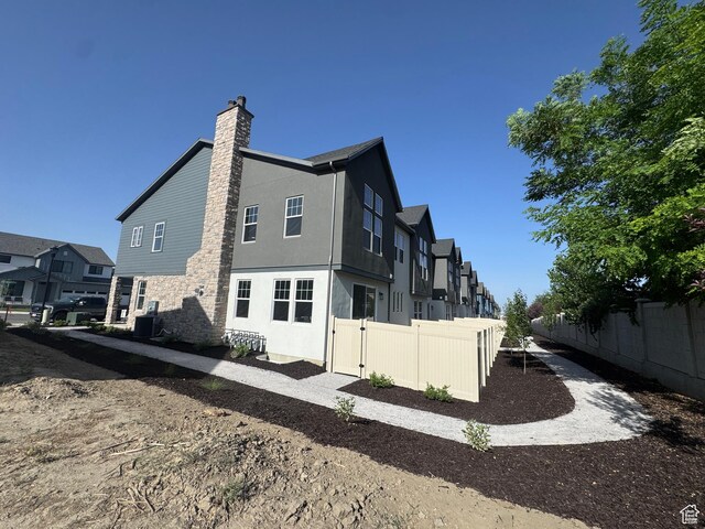 322 W Songbird Ln N Unit 24, Lindon, UT 84042 - back of house featuring a residential view, a chimney, and stucco siding