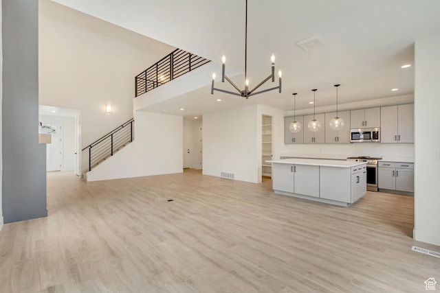 322 W Songbird Ln N Unit 24, Lindon, UT 84042 - kitchen featuring appliances with stainless steel finishes, open floor plan, light countertops, a kitchen island, and recessed lighting