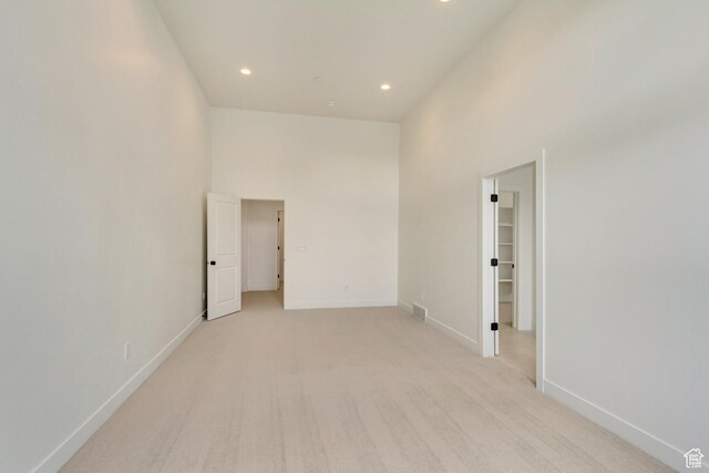 322 W Songbird Ln N Unit 24, Lindon, UT 84042 - unfurnished room featuring light colored carpet, recessed lighting, a high ceiling, and baseboards