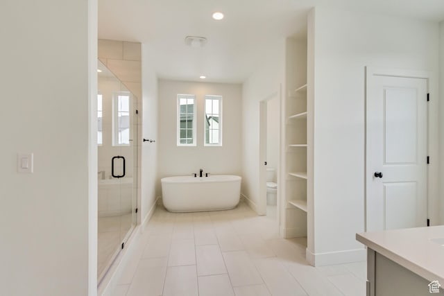 322 W Songbird Ln N Unit 24, Lindon, UT 84042 - bathroom featuring a soaking tub, vanity, a shower stall, toilet, and baseboards