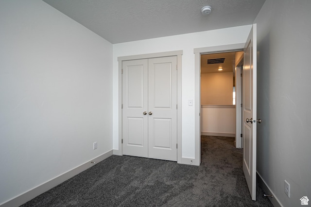 622 S 85 E Unit 4, Smithfield, UT 84335 - unfurnished bedroom featuring dark colored carpet, a closet, and baseboards