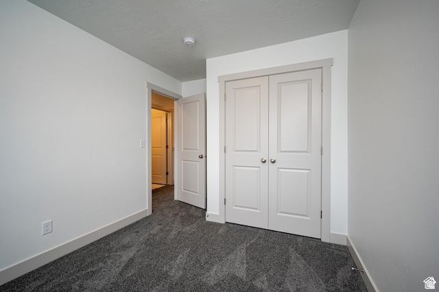 622 S 85 E Unit 4, Smithfield, UT 84335 - unfurnished bedroom with dark carpet, baseboards, and a closet