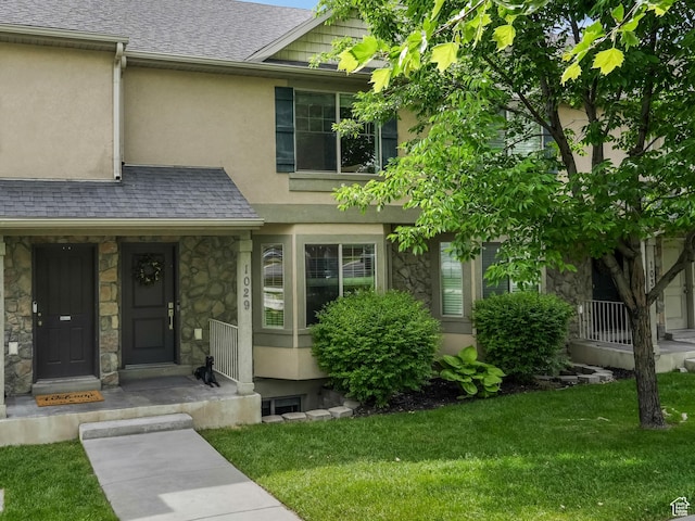 1029 Independence, Provo, UT 84604 - townhome / multi-family property featuring stone siding, stucco siding, a front yard, and roof with shingles