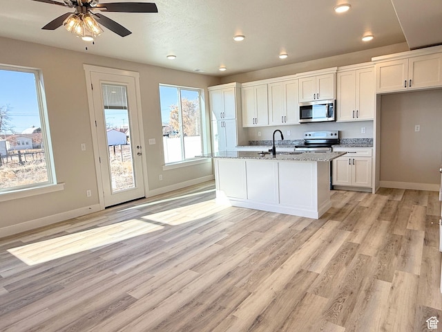 636 S 85 E Unit 6, Smithfield, UT 84335 - kitchen with appliances with stainless steel finishes, baseboards, white cabinetry, light wood-style floors, and recessed lighting