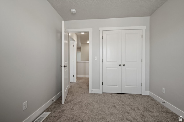 636 S 85 E Unit 6, Smithfield, UT 84335 - unfurnished bedroom with carpet floors, a closet, baseboards, and a textured ceiling