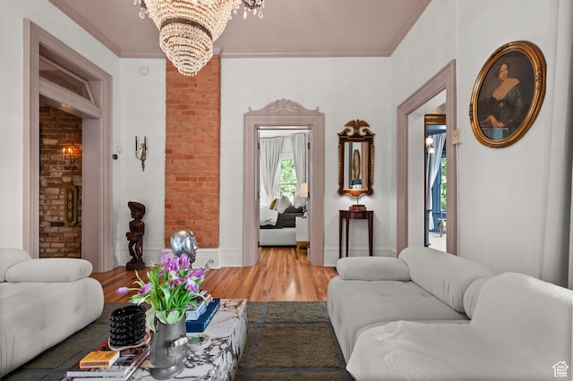 237 E 4th Ave N, Salt Lake City, UT 84103 - living room featuring a chandelier, light wood-style floors, brick wall, and ornamental molding