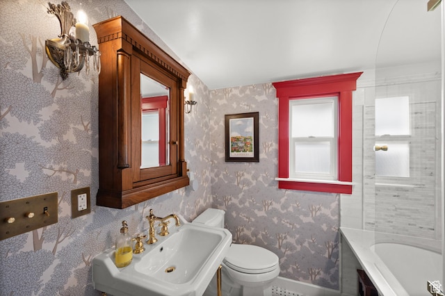 237 E 4th Ave N, Salt Lake City, UT 84103 - full bath featuring baseboards, wallpapered walls, toilet, a sink, and a tub to relax in