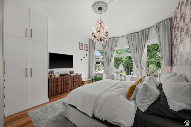 237 E 4th Ave N, Salt Lake City, UT 84103 - bedroom featuring multiple windows, a chandelier, and wood finished floors