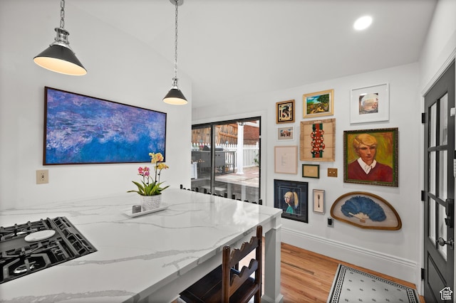 237 E 4th Ave N, Salt Lake City, UT 84103 - kitchen with wood finished floors, light stone counters, pendant lighting, and baseboards