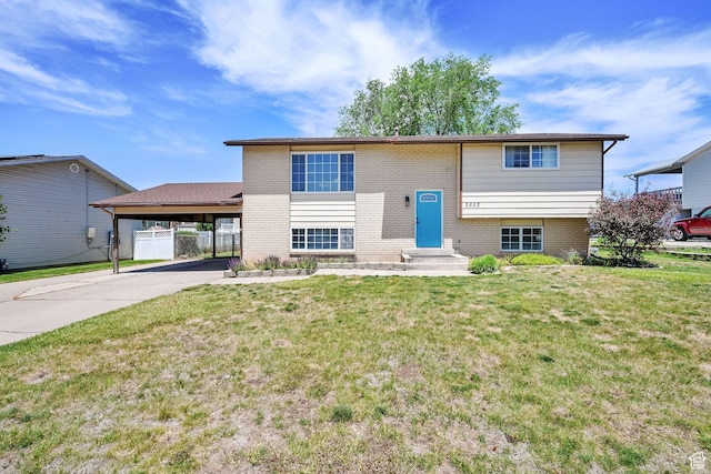 2652 W 6050 S, Roy, UT 84067 - view of front of house with an attached carport, concrete driveway, brick siding, and a gate