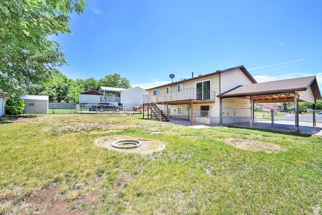 2652 W 6050 S, Roy, UT 84067 - back of property with an outdoor fire pit, stairway, and a carport