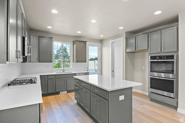 11839 S Harvest Gold Way, Riverton, UT 84065 - kitchen featuring appliances with stainless steel finishes, a sink, gray cabinetry, tasteful backsplash, and recessed lighting