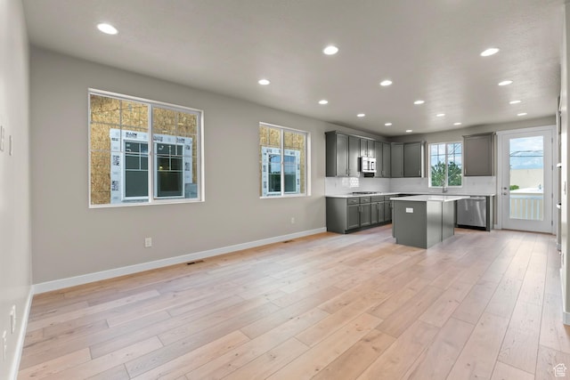 11839 S Harvest Gold Way, Riverton, UT 84065 - kitchen with appliances with stainless steel finishes, a kitchen island, recessed lighting, light countertops, and light wood-type flooring