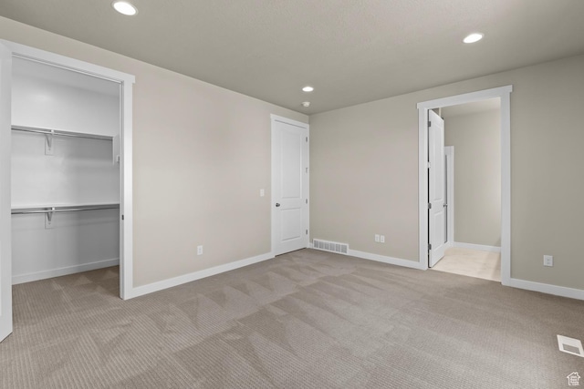 11839 S Harvest Gold Way, Riverton, UT 84065 - unfurnished bedroom with carpet floors, recessed lighting, a walk in closet, and baseboards