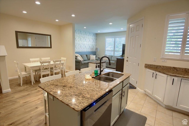 58 N 285 W, Centerville, UT 84014 - kitchen featuring dishwasher, a sink, baseboards, light stone counters, and an island with sink