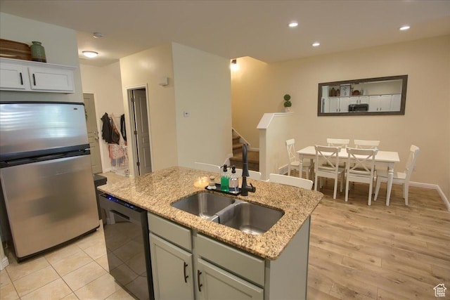 58 N 285 W, Centerville, UT 84014 - kitchen featuring freestanding refrigerator, dishwasher, a sink, an island with sink, and light stone countertops