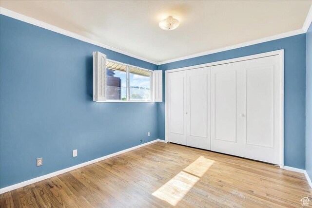 5424 S 850 E, South Ogden, UT 84405 - unfurnished bedroom with ornamental molding, baseboards, wood finished floors, and a closet