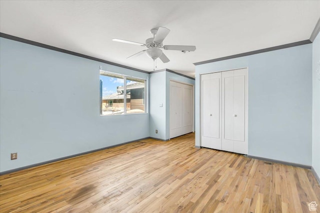 5424 S 850 E, South Ogden, UT 84405 - unfurnished bedroom featuring ornamental molding, light wood-style flooring, multiple closets, baseboards, and a ceiling fan