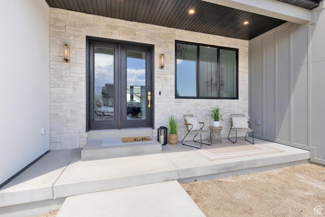 6552 W Timber Ranch Dr, Herriman, UT 84096 - property entrance featuring board and batten siding, stone siding, and french doors