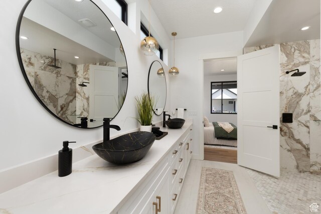 6552 W Timber Ranch Dr, Herriman, UT 84096 - ensuite bathroom featuring double vanity, recessed lighting, and a marble finish shower
