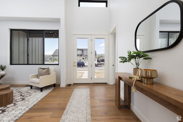 6552 W Timber Ranch Dr, Herriman, UT 84096 - entryway featuring wood finished floors, baseboards, and a towering ceiling