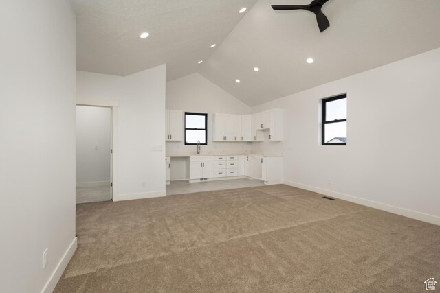 6552 W Timber Ranch Dr, Herriman, UT 84096 - unfurnished living room featuring high vaulted ceiling, light colored carpet, a ceiling fan, baseboards, and recessed lighting