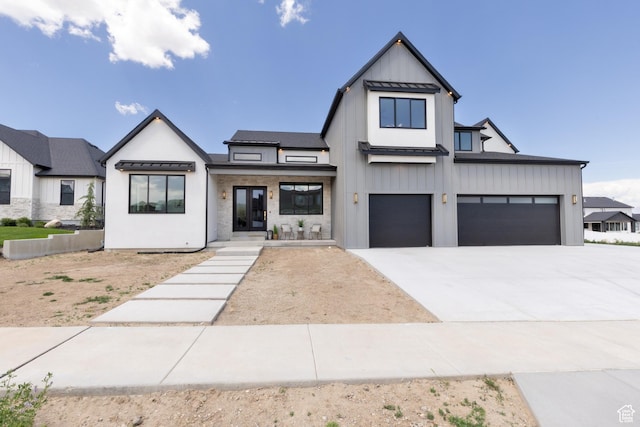 6552 W Timber Ranch Dr, Herriman, UT 84096 - modern farmhouse style home featuring concrete driveway, board and batten siding, an attached garage, and a standing seam roof